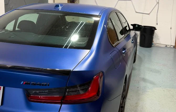 window tinting on blue sedan